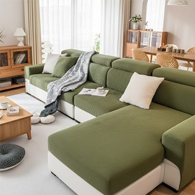 Un grand canapé d'angle blanc équipé d'une protection canapé chat vert, installé dans un salon moderne et chaleureux en bois clair