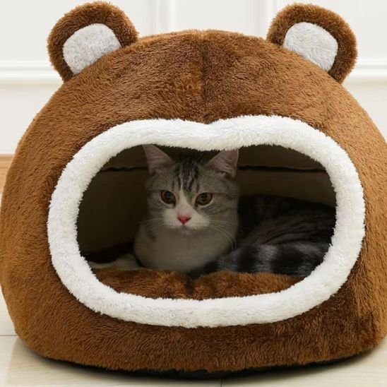 Panier pour chat en forme de tête d'ours avec un chat installé à l'intérieur